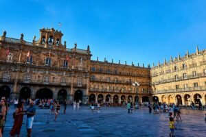 Living in Spain during winter: a Spanish plaza at dusk with twinkling lights.