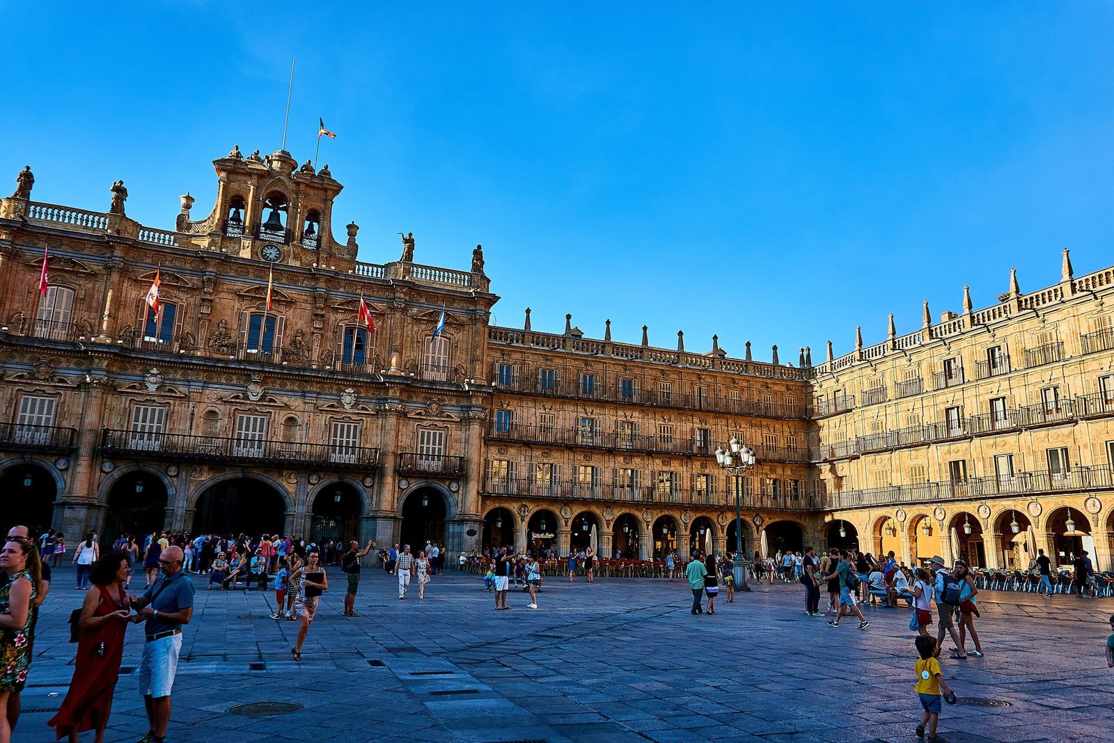 Living in Spain during winter: a Spanish plaza at dusk with twinkling lights.