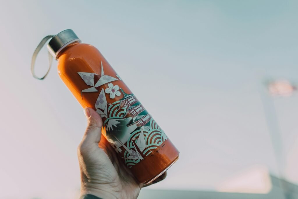 Reducing plastic waste: refilling a reusable water bottle in Spain.